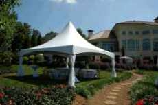20x20 High Peak White tent with walkway and trees and house in background.