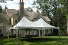 20x30 High Peak White tent with house in background and setup on grass.
